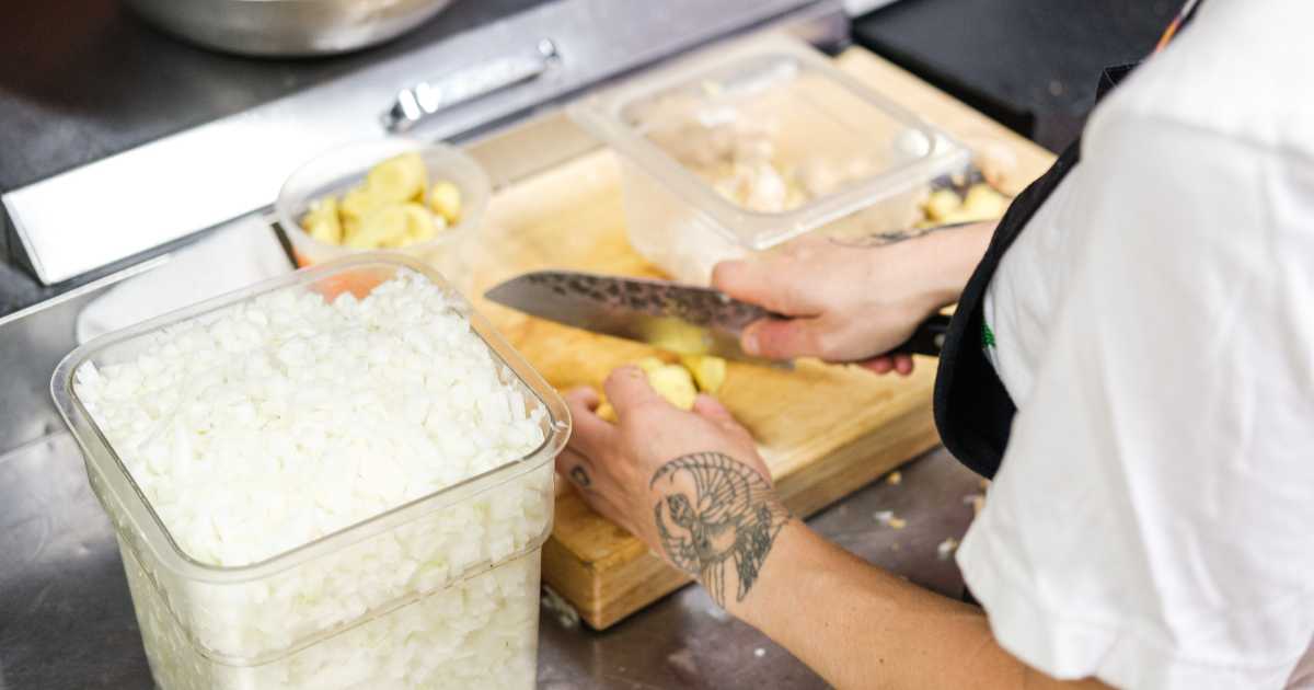 Kitchen staff preparing pizzas